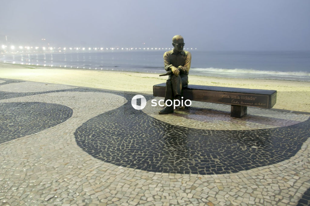 Couple sitting on bench near sea