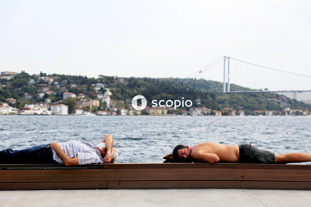 Couple sitting on brown wooden bench