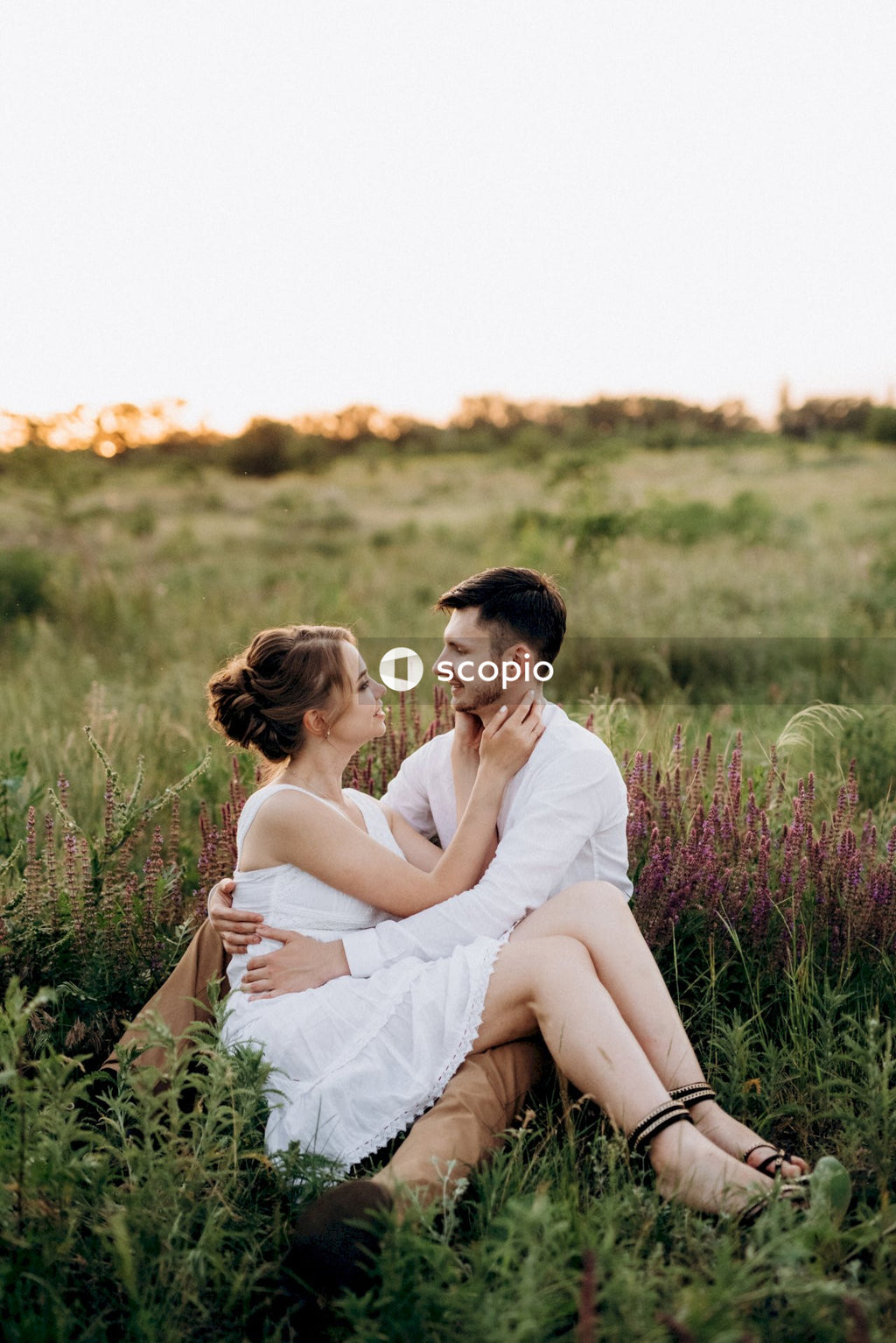 Couple sitting on green grass field