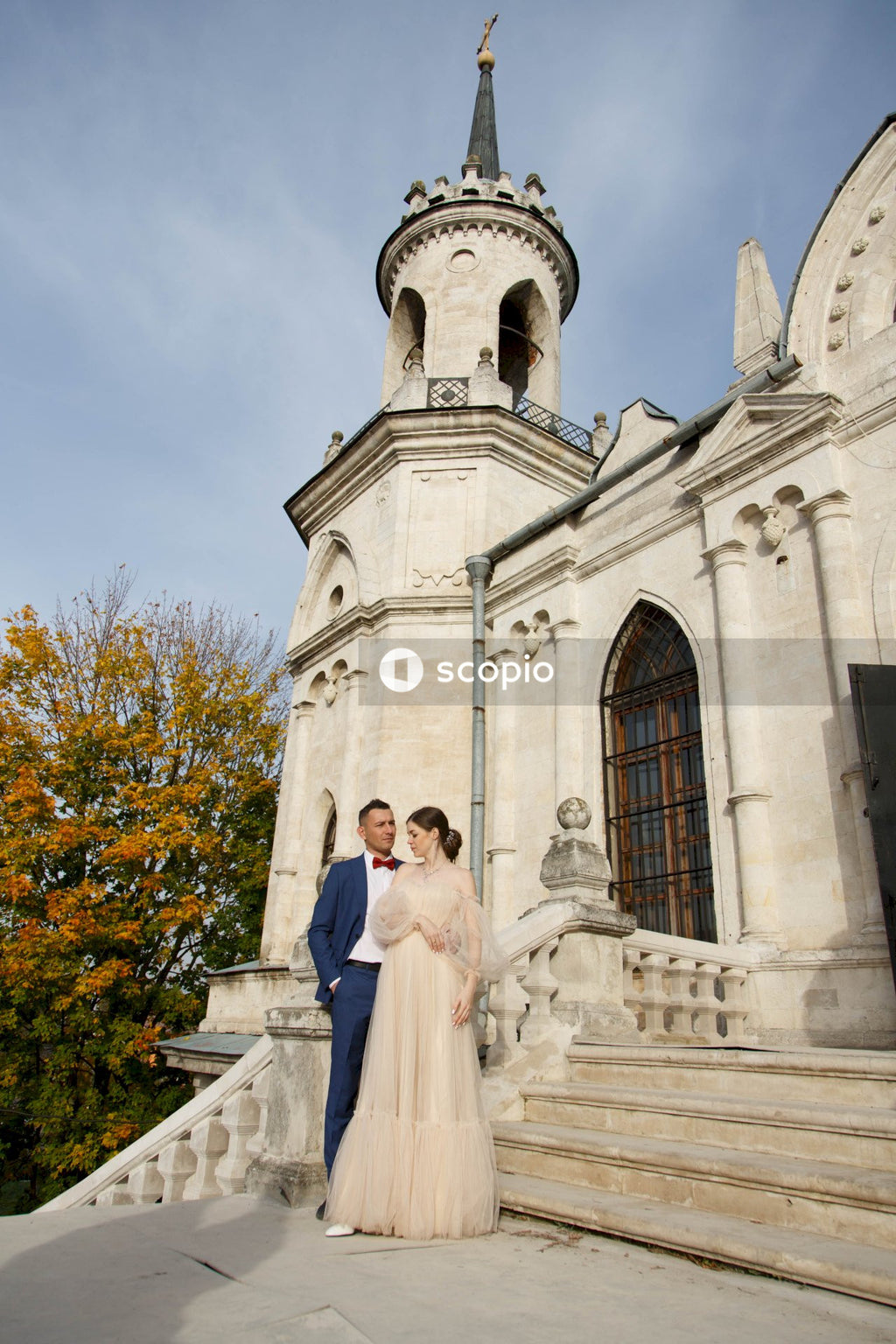 Couple standing in front of white concrete building