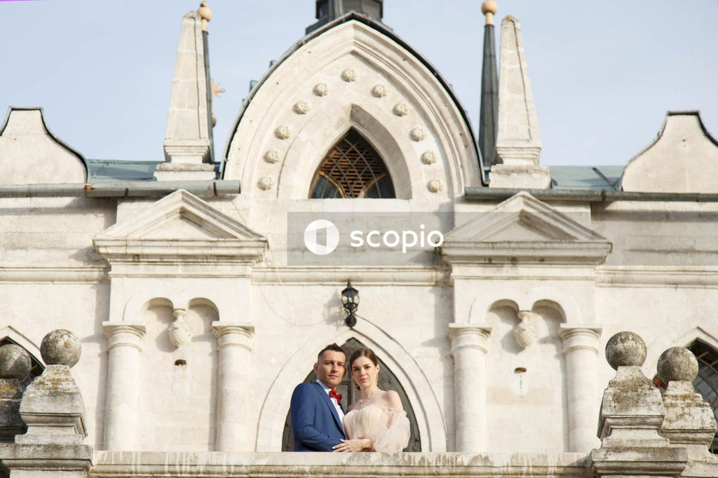 Couple standing in front of white concrete building