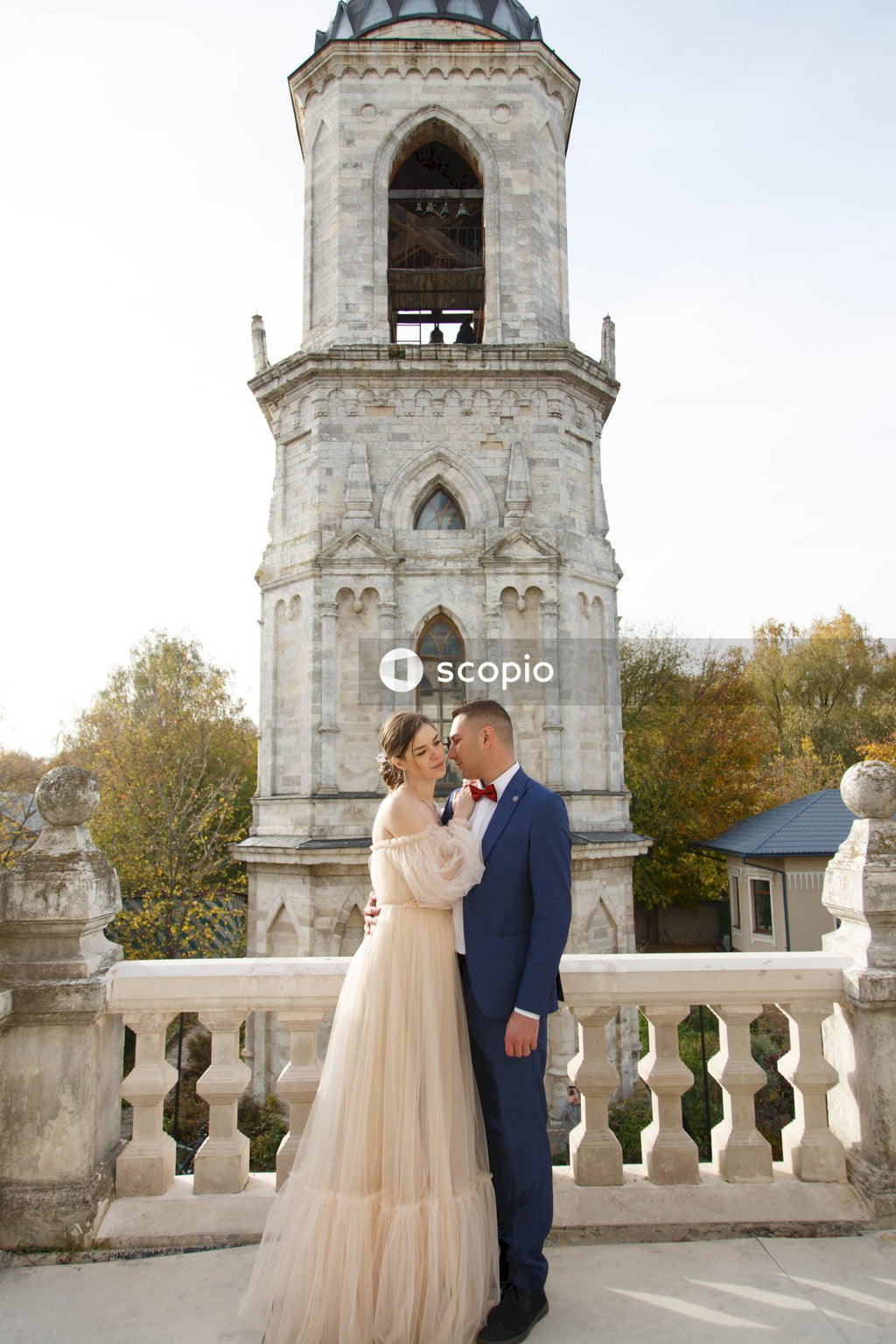Couple standing in front of white concrete building