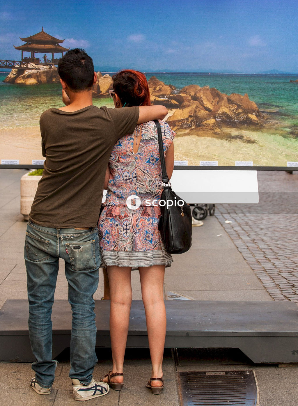 Couple standing on gray concrete floor