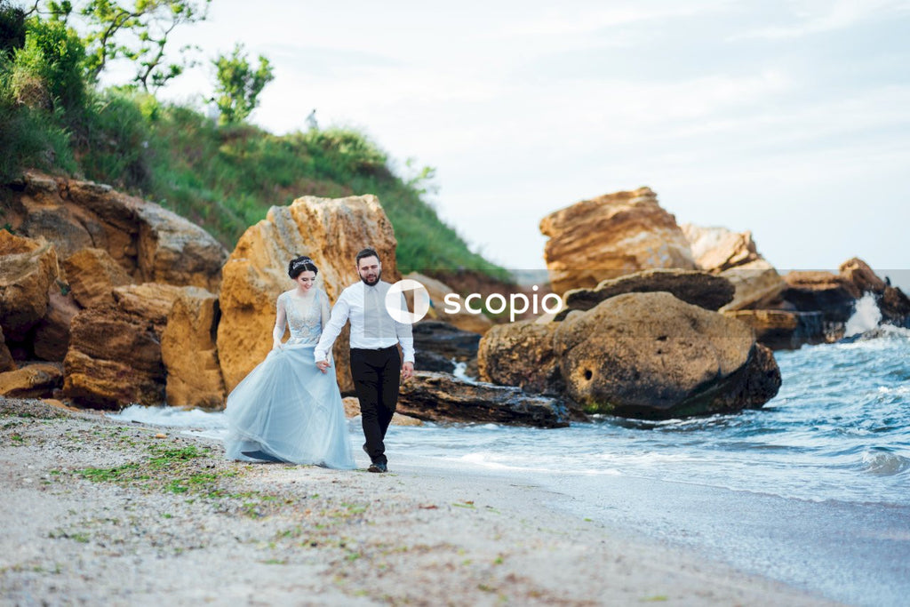 Couple standing on rocky shore