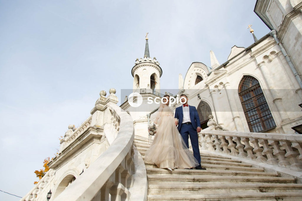Couple standing on white concrete building