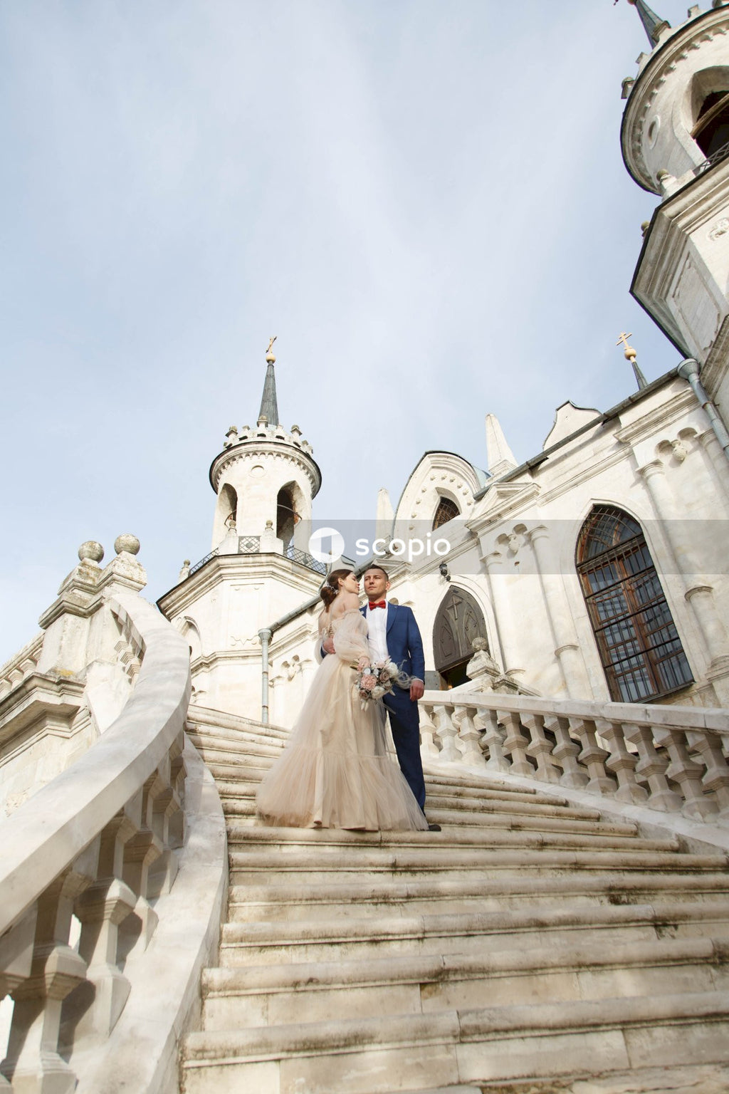 Couple standing on white concrete building