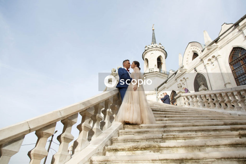 Couple walking on white concrete staircase