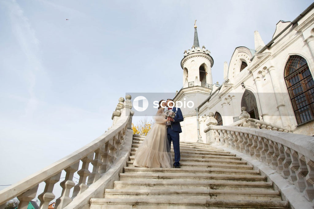 Couple walking on white concrete staircase