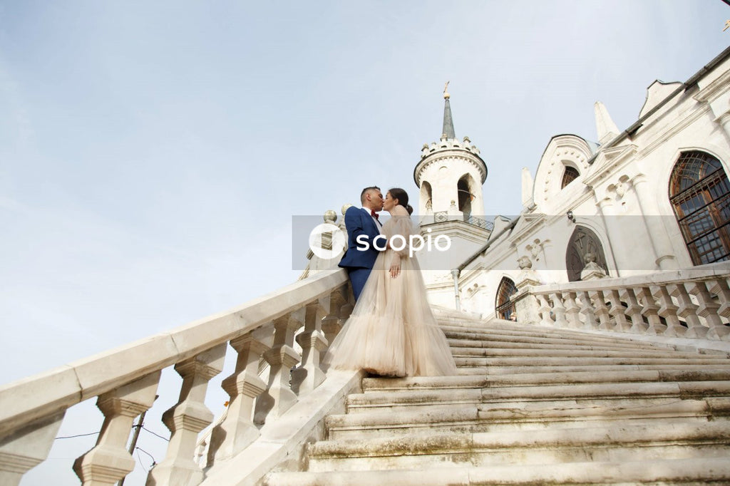 Couple walking on white concrete staircase