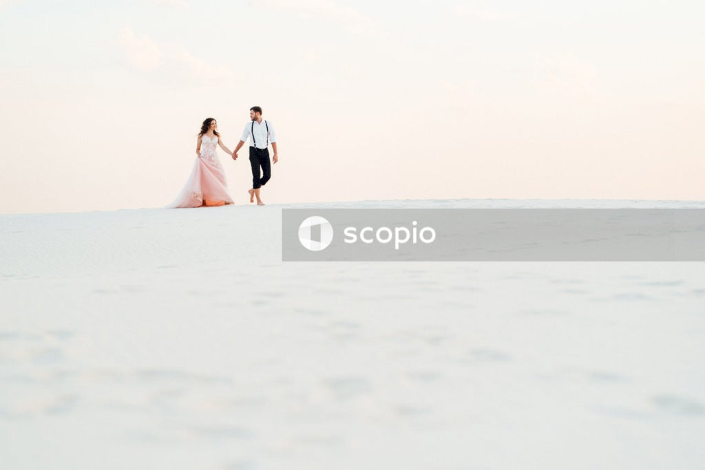 Couple walking on white sand
