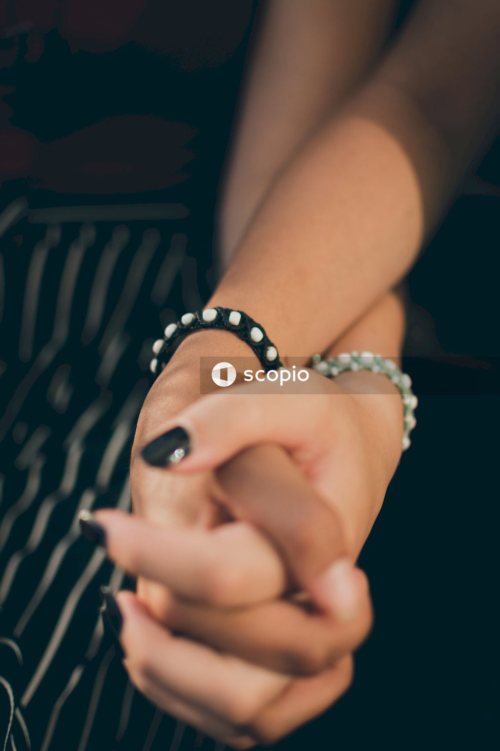 Cropped image of two interracial women holding hands
