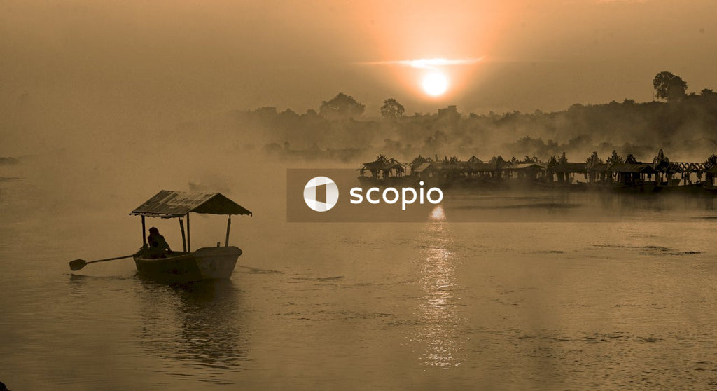 Silhouette of people riding boat on water during sunset