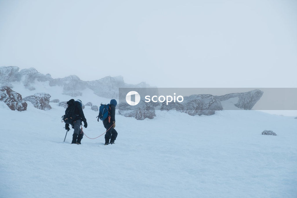 Two people hiking on snow covered ground