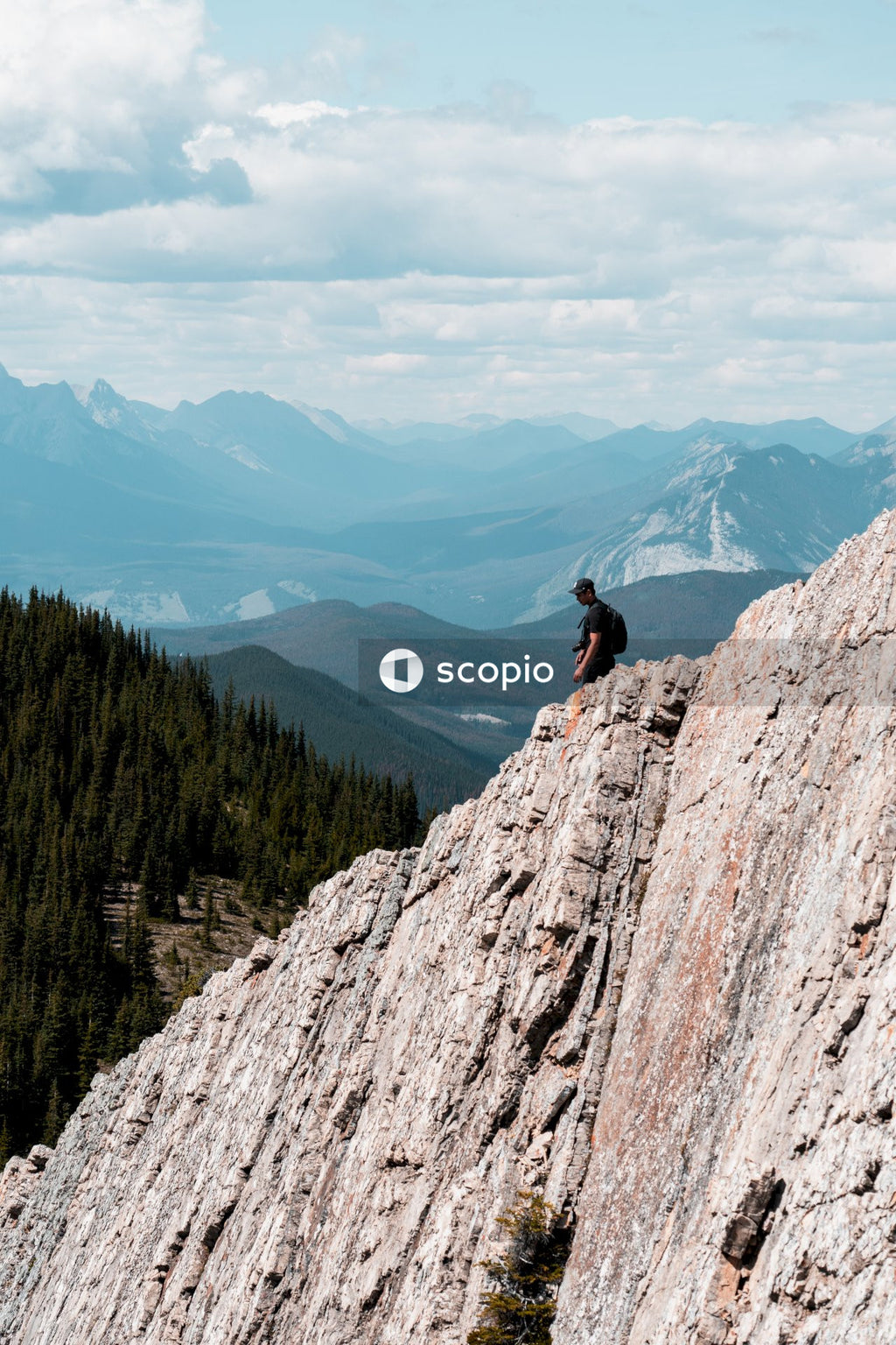 Man Enjoying Breathtaking View of Mountains and Valley