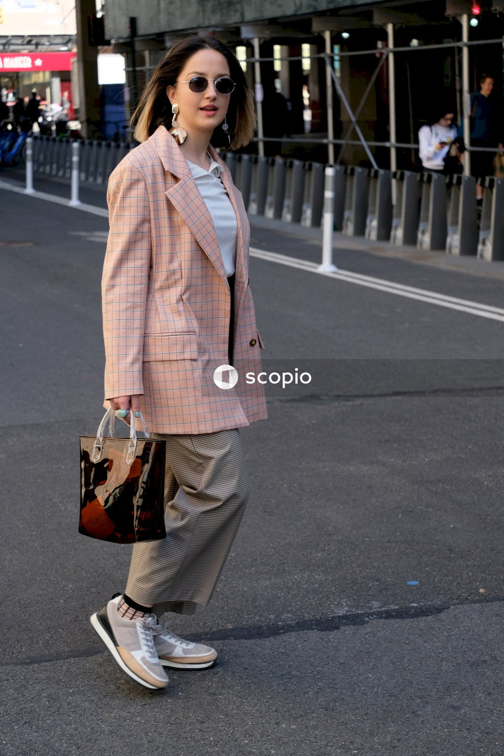 Stylish woman walking down the street with glasses