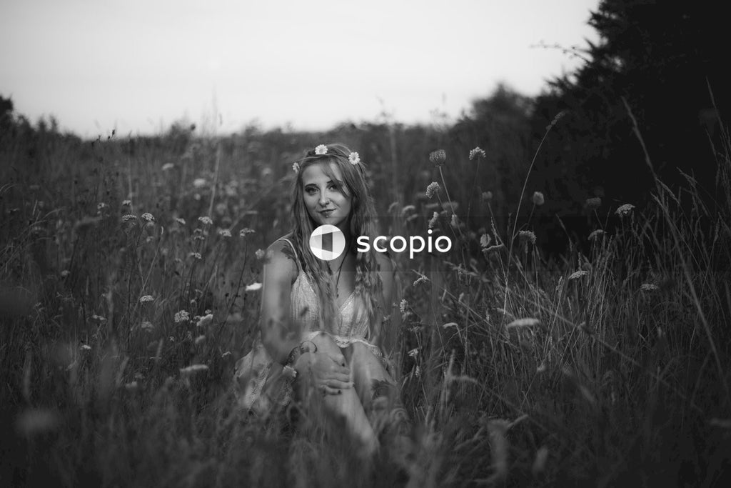 Grayscale photo of woman in grass field