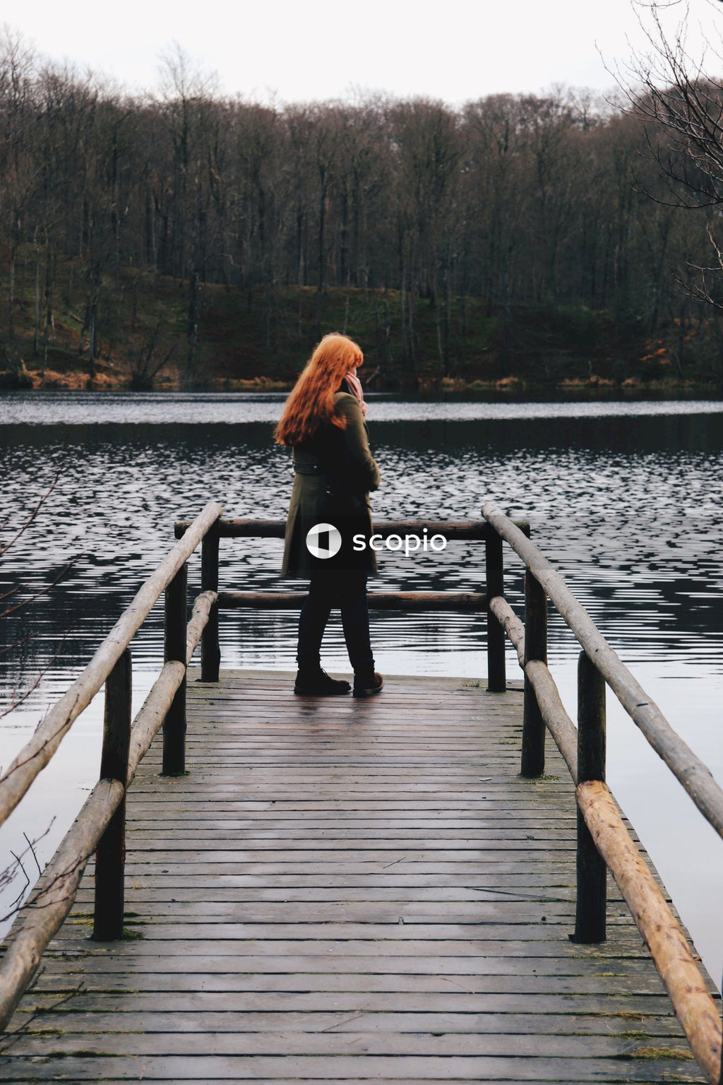 Red head woman standing on dock