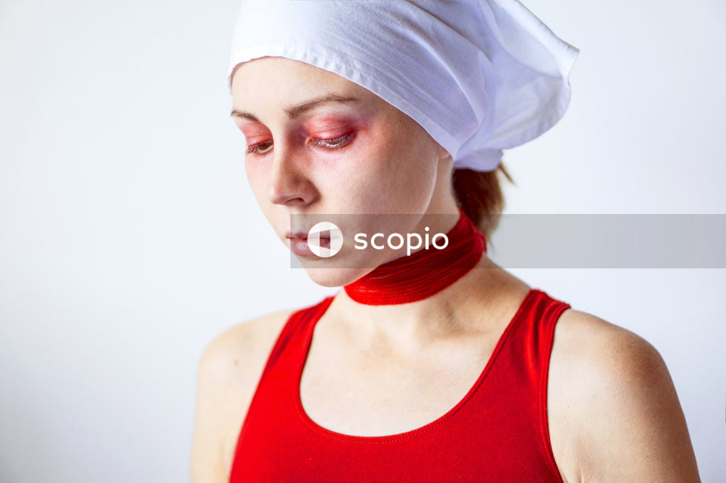 Woman in Red Tank Top Wearing White Bandana