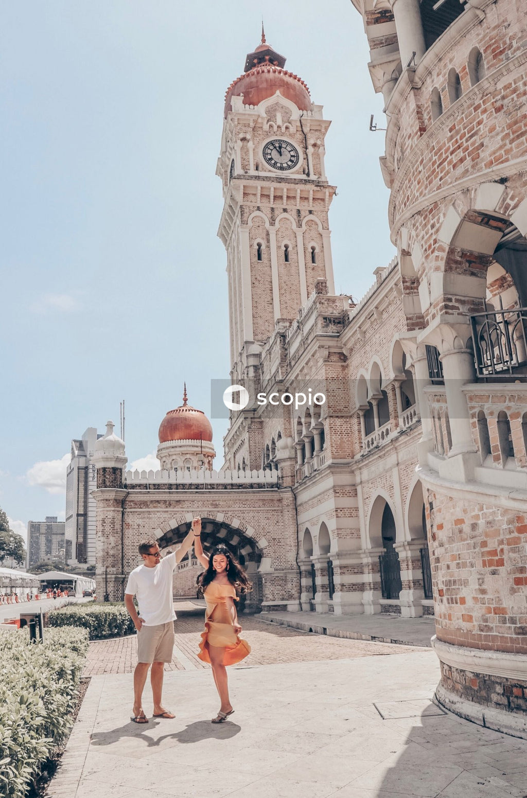 Dancing man and woman near Sultan Abdul Samad Building in Kuala Lumpur, Malaysia