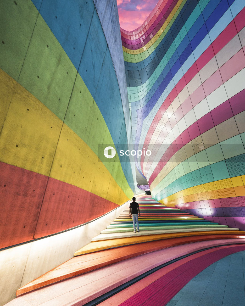 Person in multi-colored building