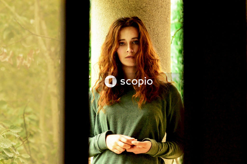 Woman wearing green sweater standing outdoor
