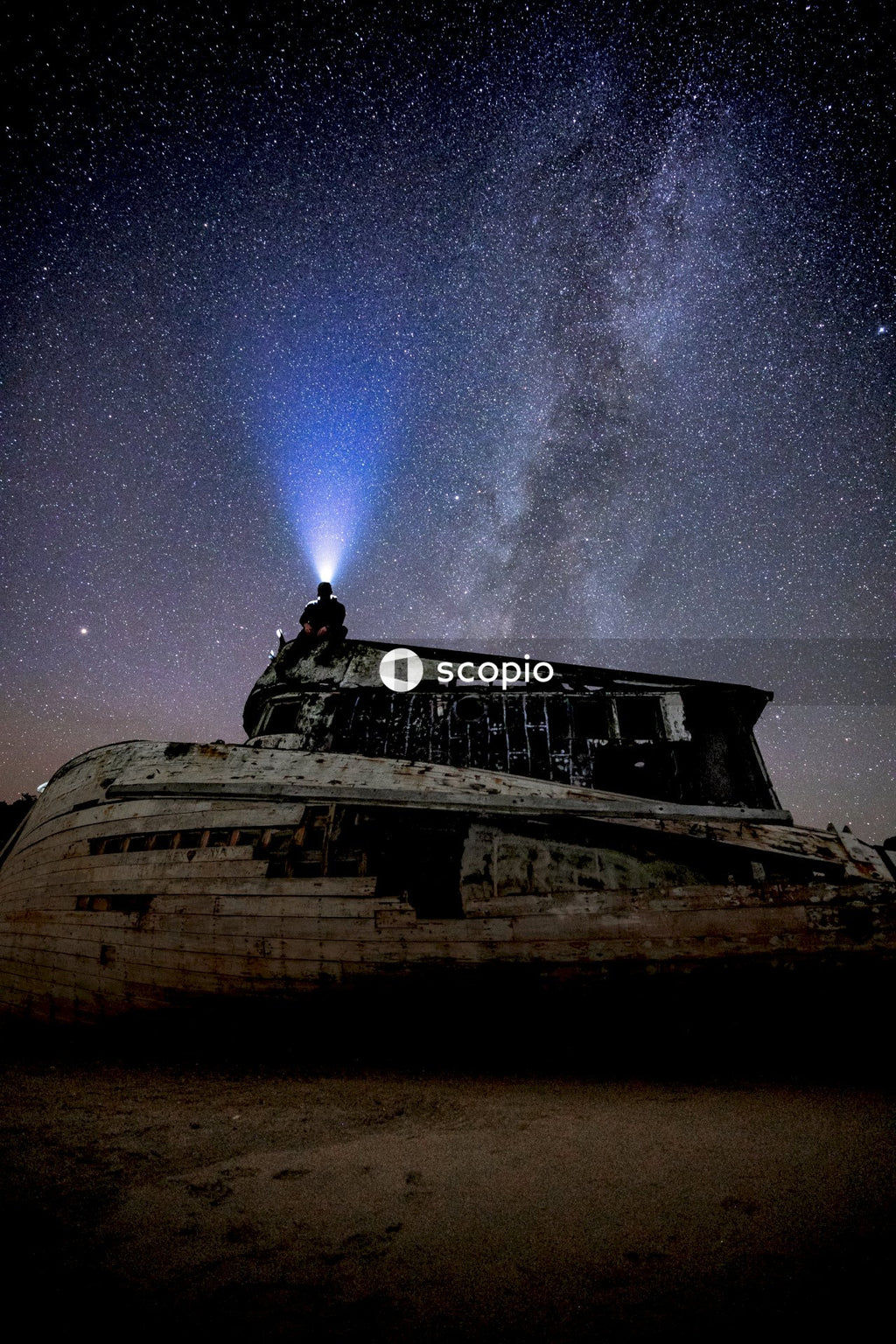 Brown and white wooden boat under starry night