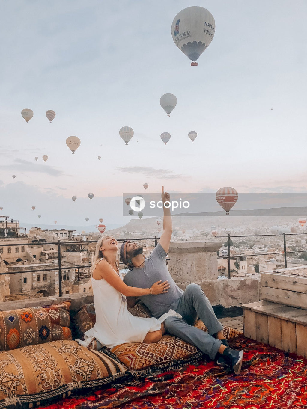 Man and woman looking at hot air balloon in sky