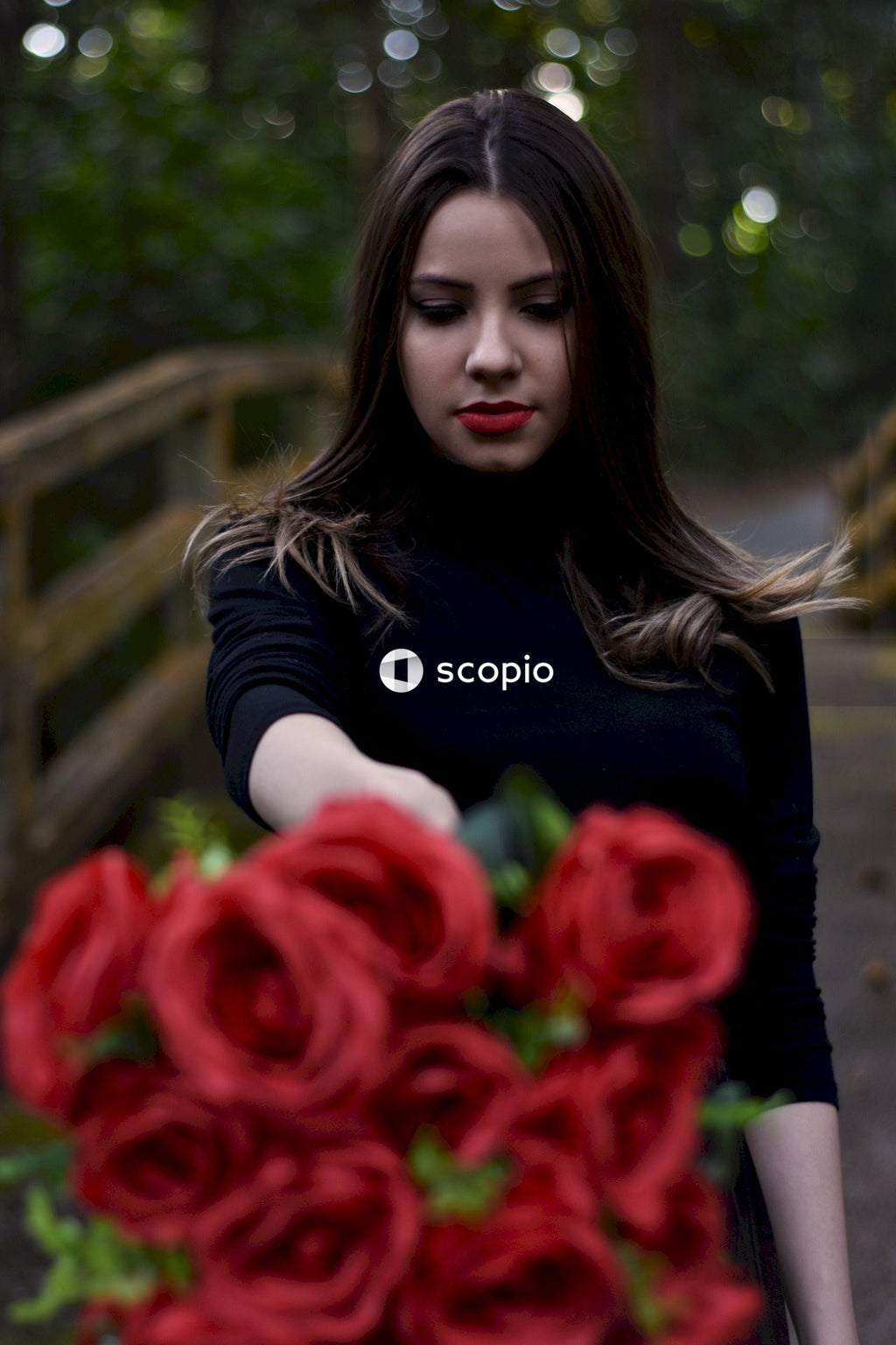 Person With a Bouquet of Roses a Symbol of Love and Mystery