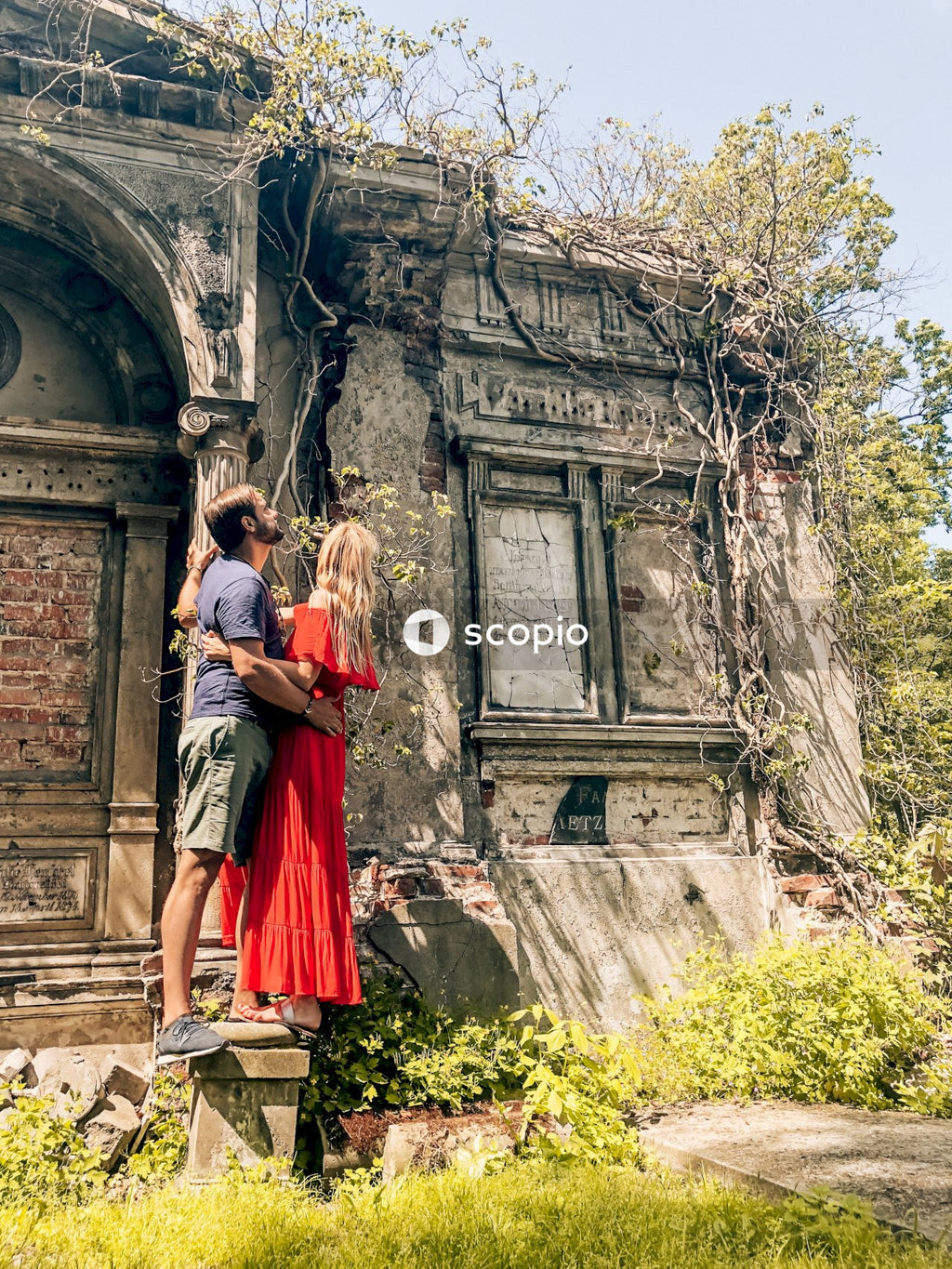 Man and woman hugging near building