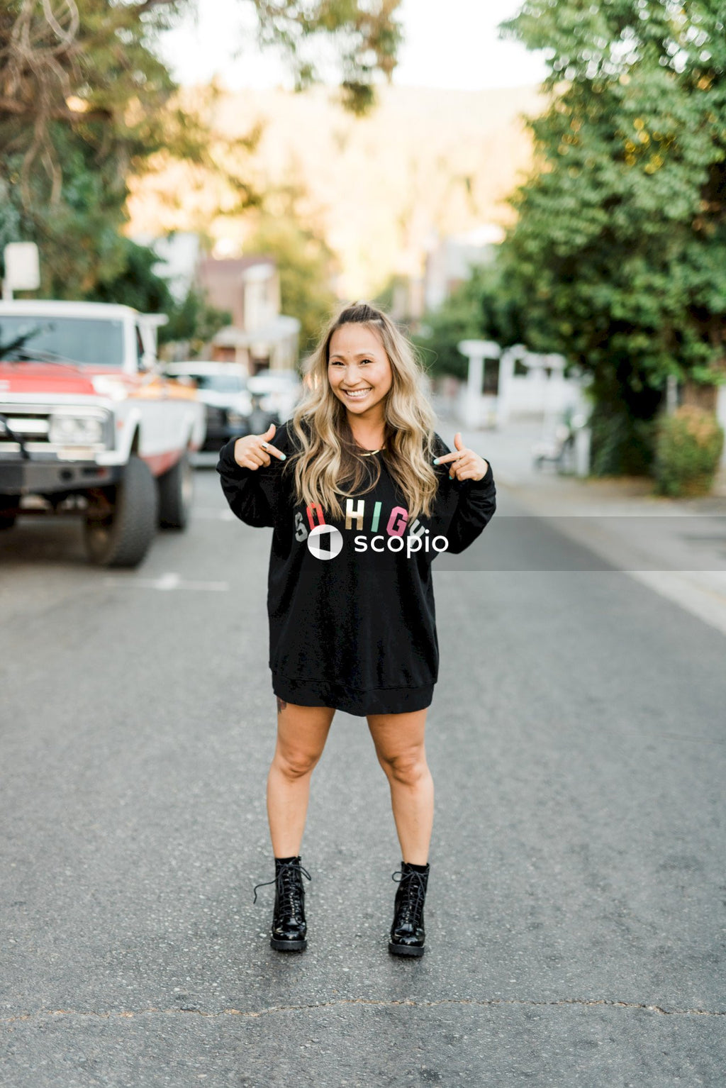 Woman in dark sweater posing outdoor
