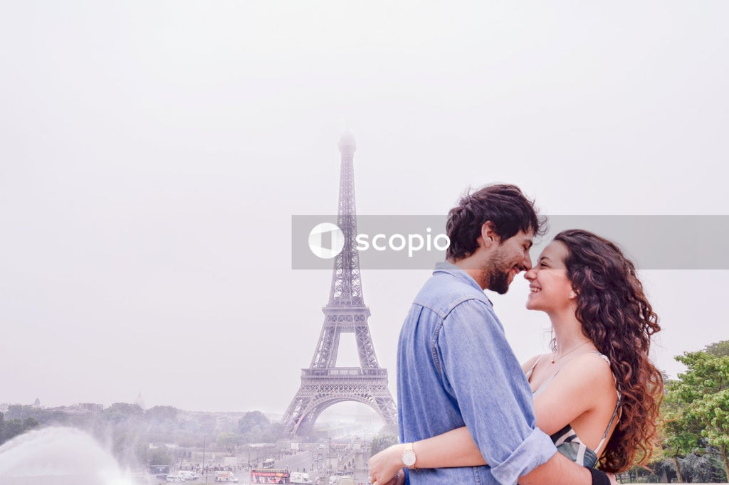 Man and woman kissing near eiffel tower