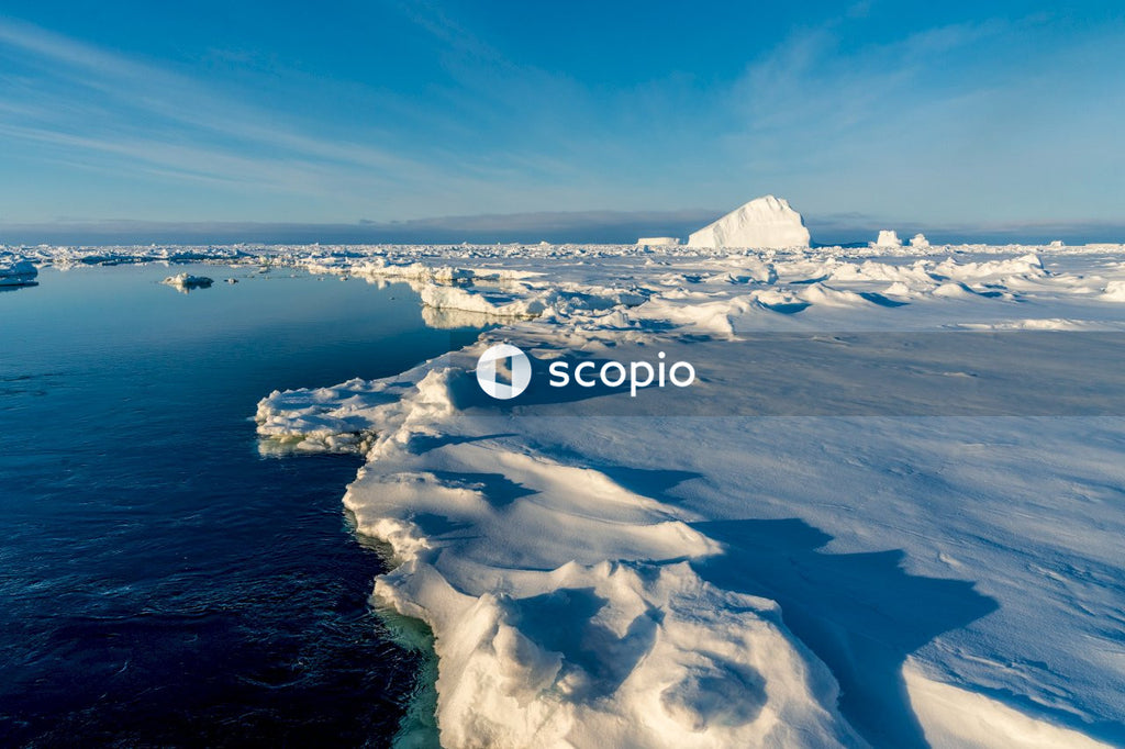 View of Arctic Ocean With Majestic Icebergs and Clear Sky