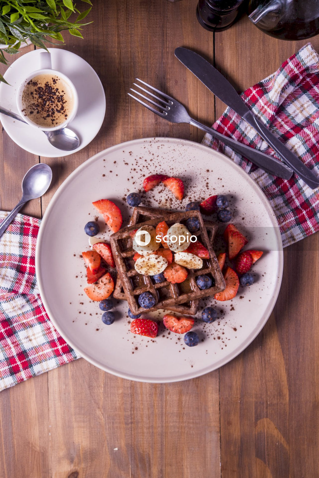 Cooked food on blue ceramic plate beside stainless steel spoon and white ceramic mug