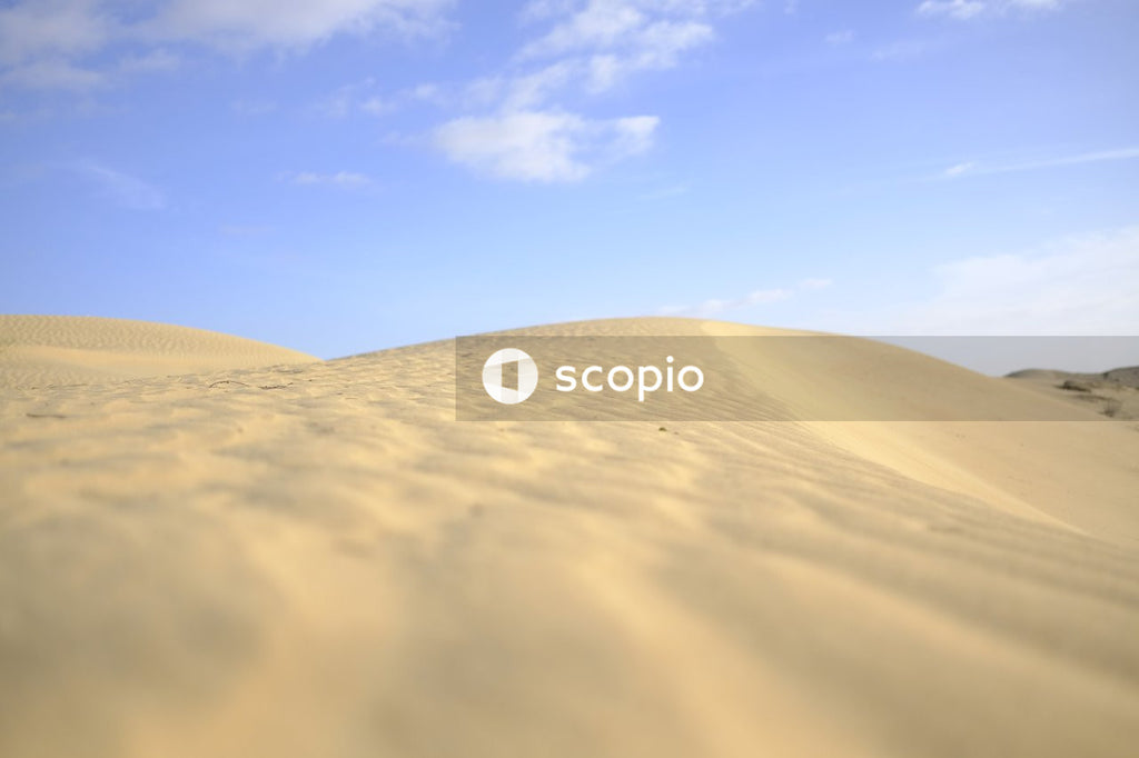 Brown sand under blue sky