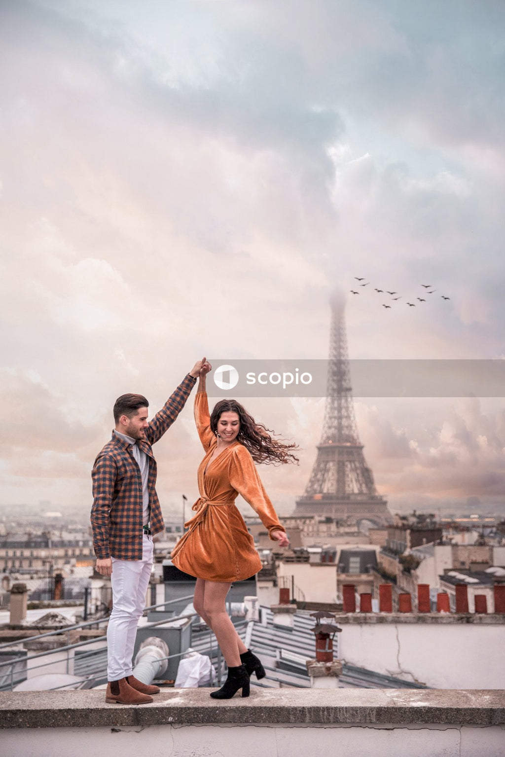 Man and woman standing on the roof of the building