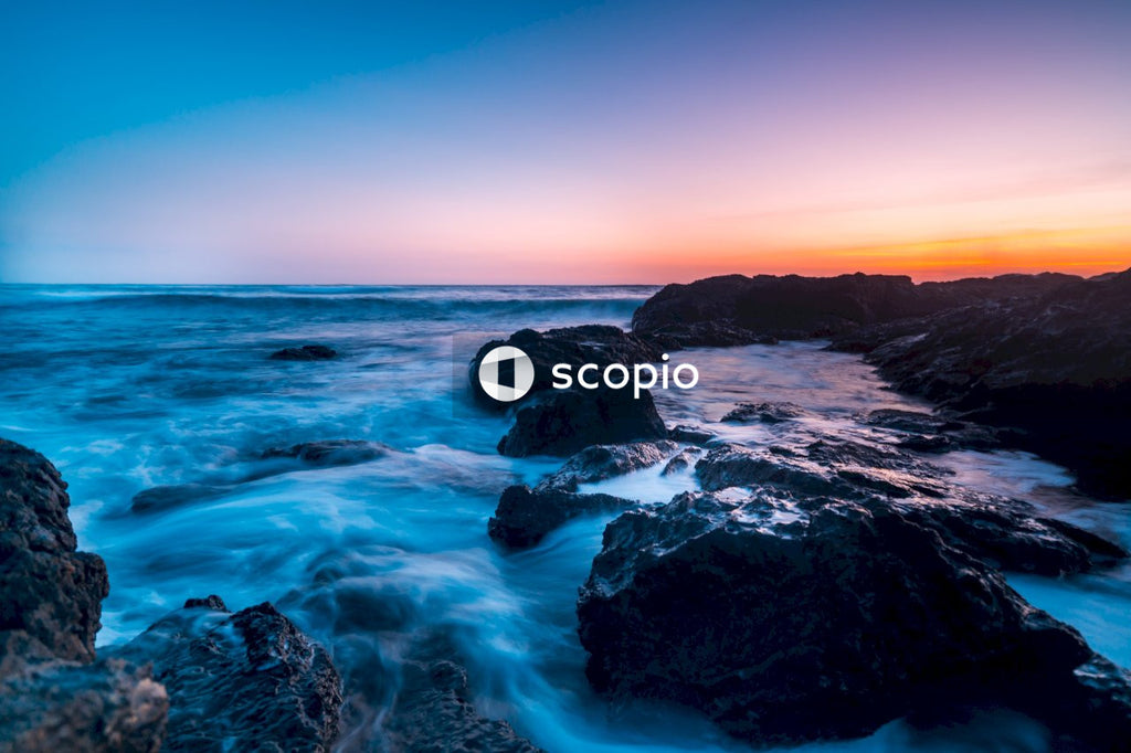 Rocky shore with water waves during sunset