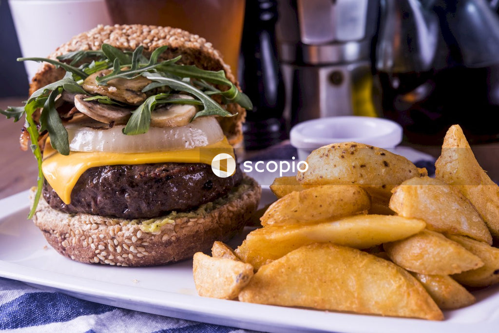 Delicious Burger With Cheese and Mushrooms Accompanied by Crispy Fries