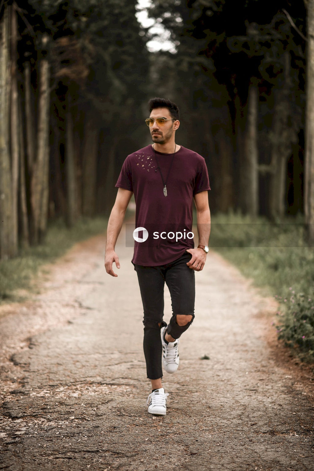 Man standing between trees