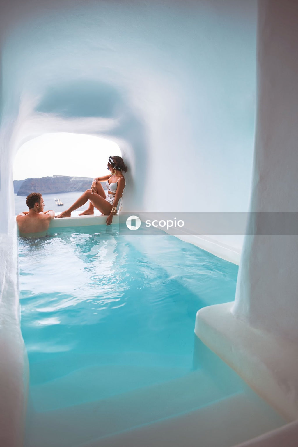 Couple in small pool with view of sea