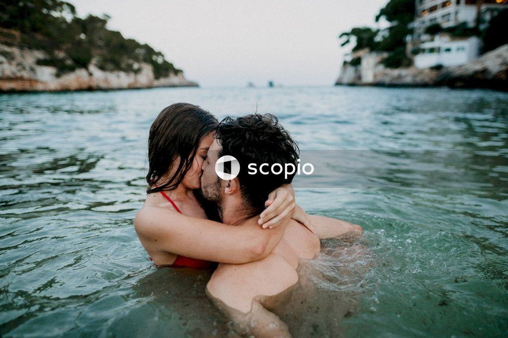 Couple swimming and kissing each other