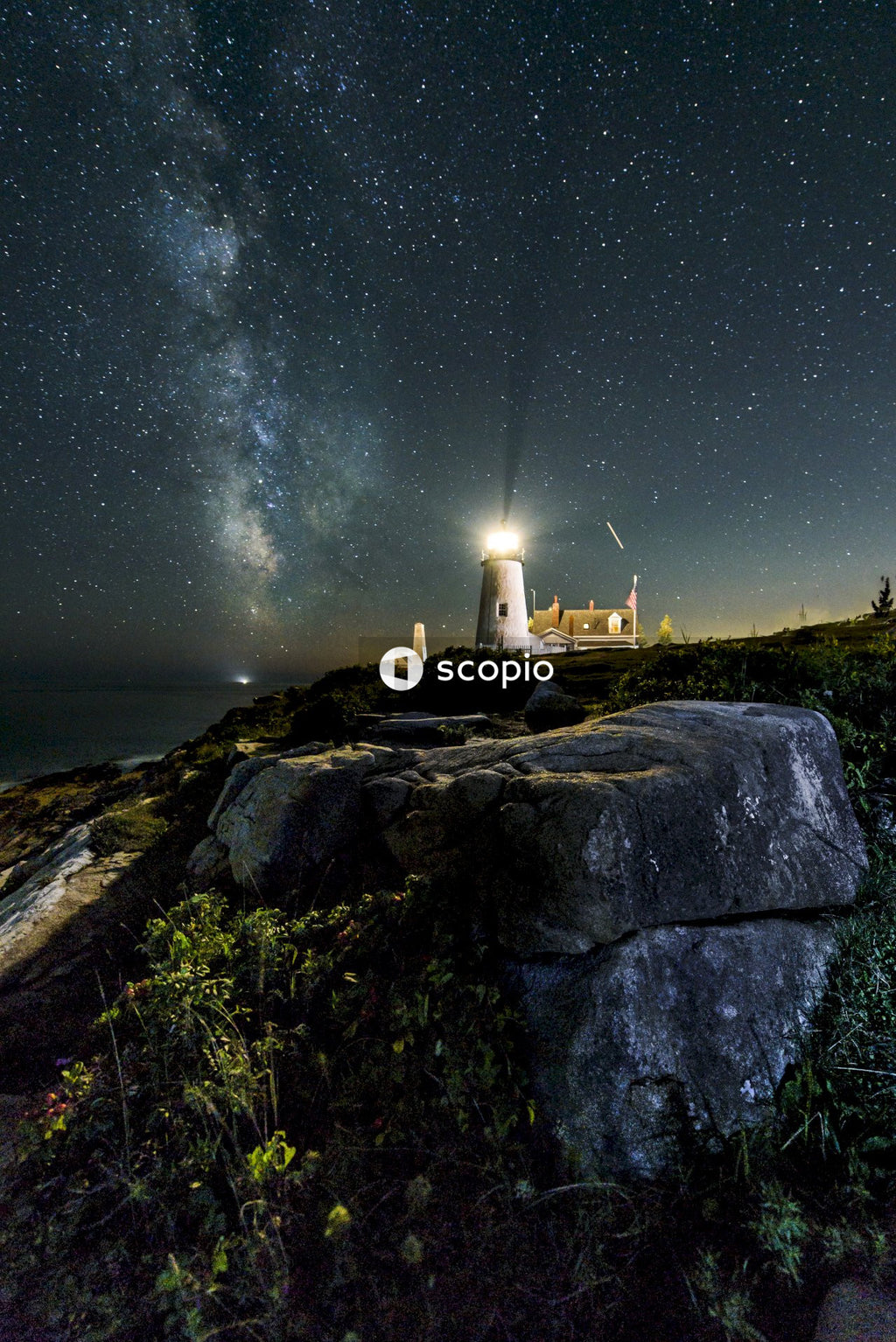 White lighthouse on top of mountain during night time