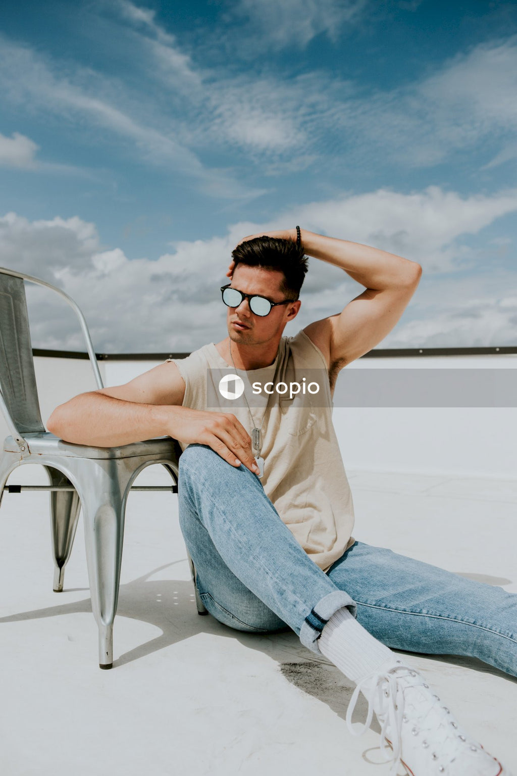 Man in blue denim jeans sitting beside