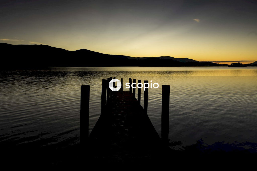 Brown wooden dock on body of water