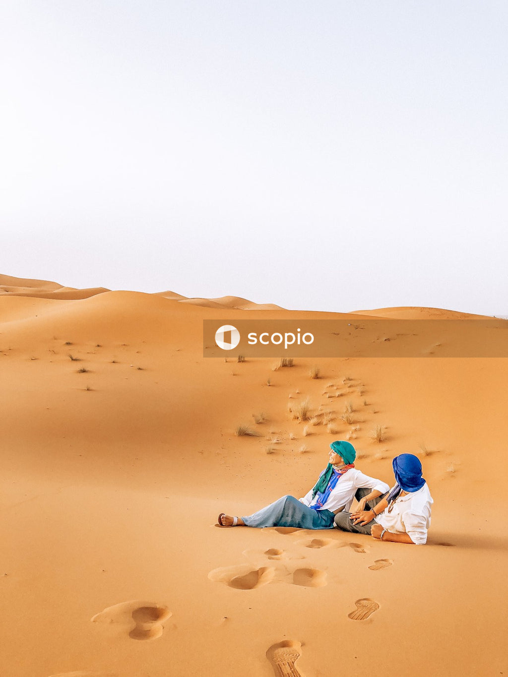 Couple sitting on desert sand