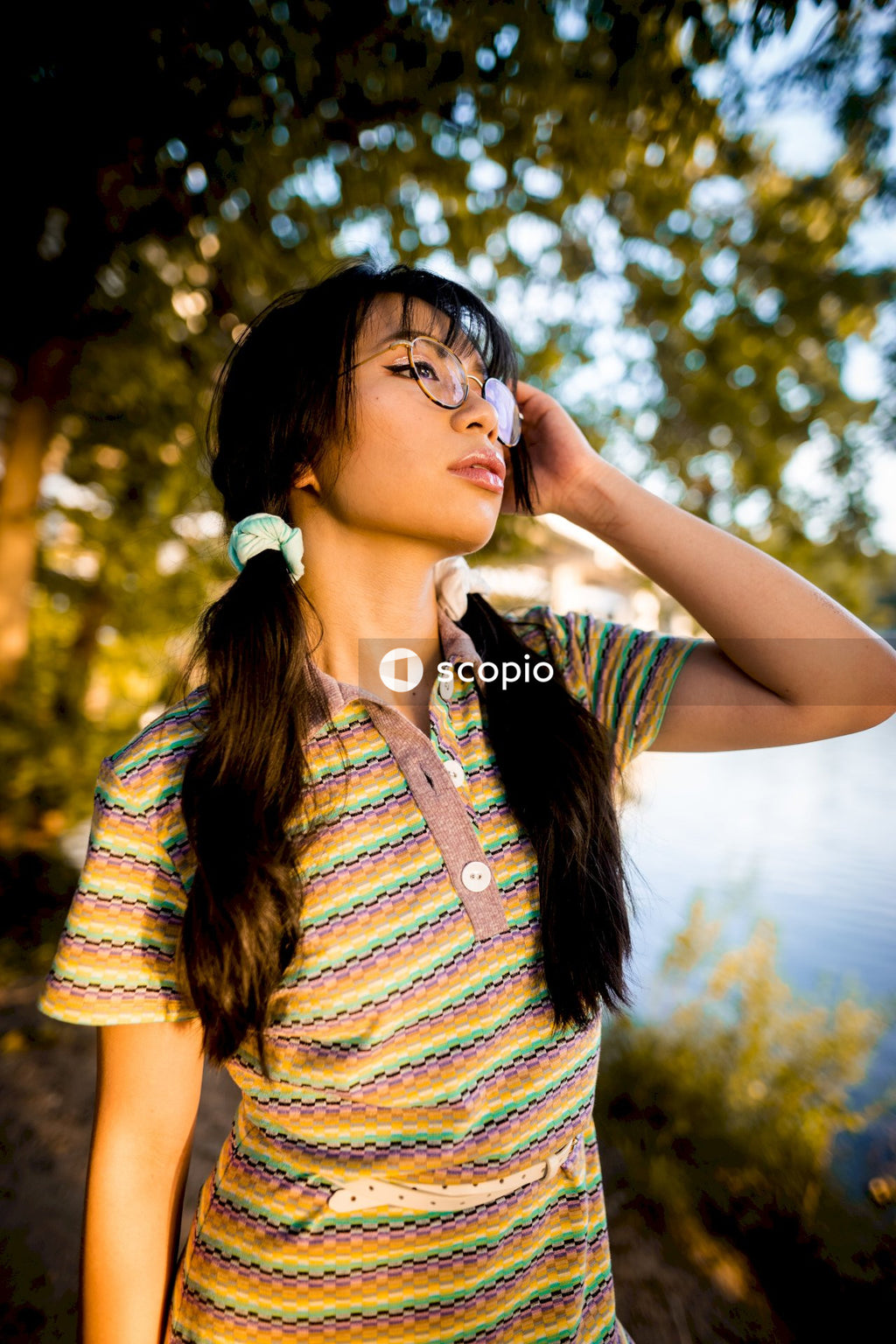 Woman with eyeglasses standing under tree