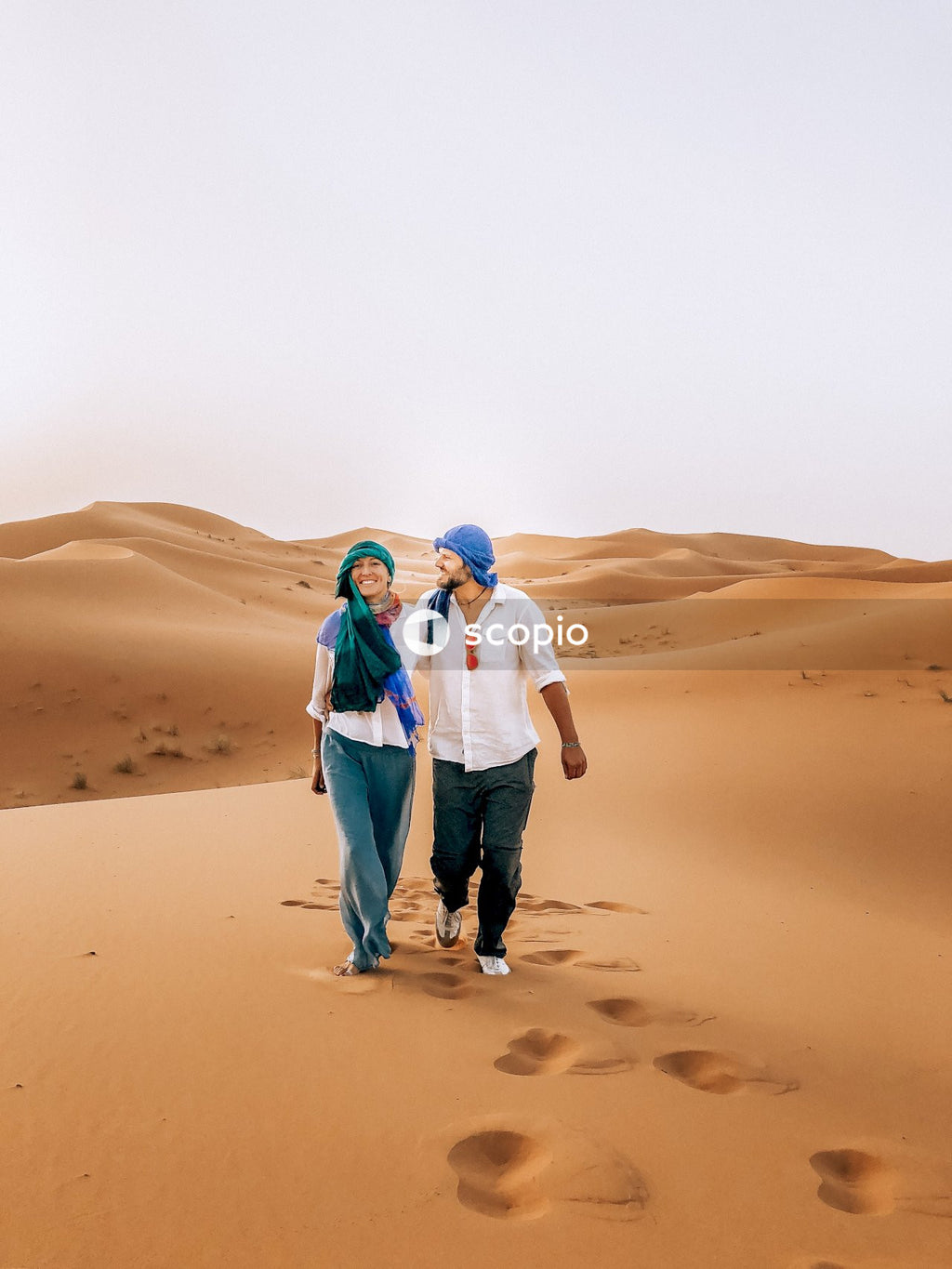 Man and woman walking on desert