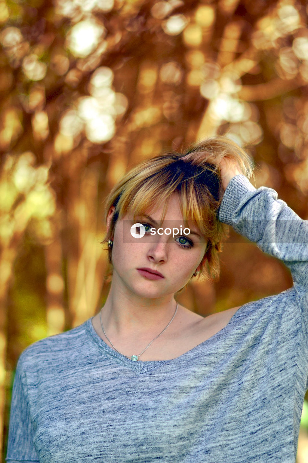 Portrait of young woman with blue eyes wearing blue shirt