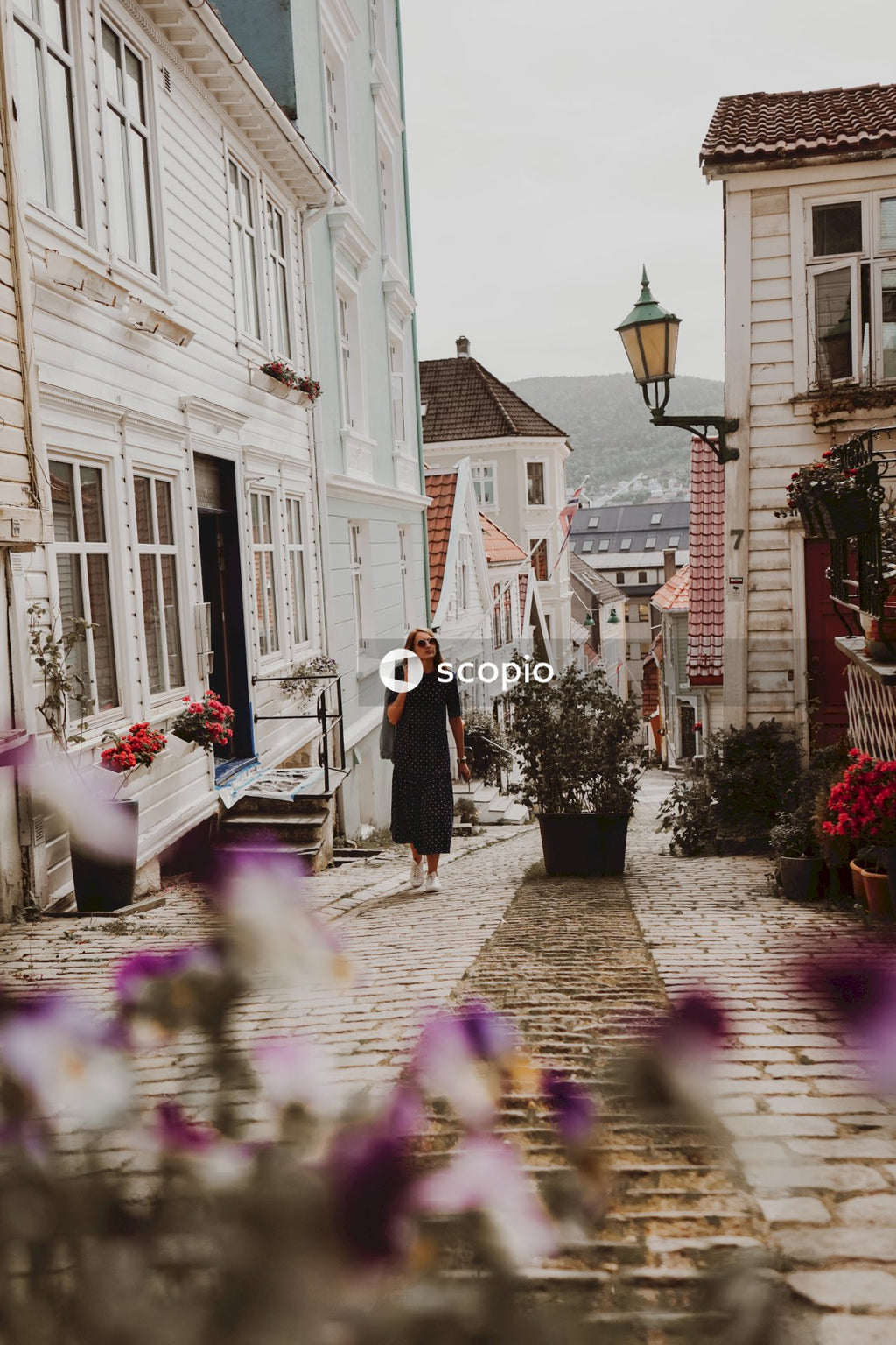 Woman in black dress walking on street