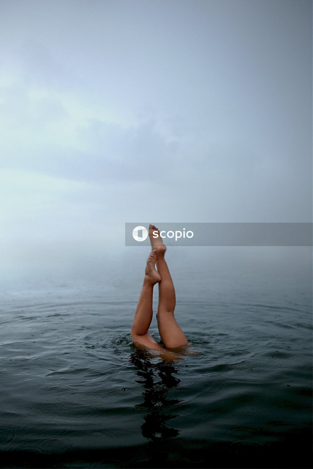 A person's legs above water