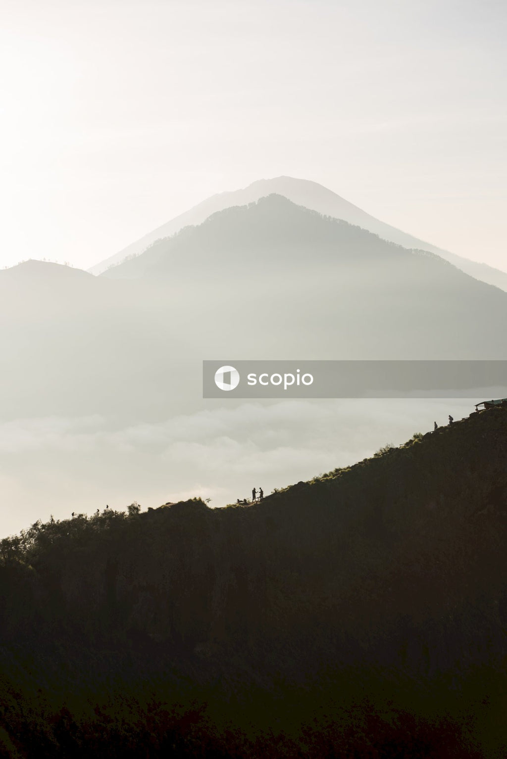 Silhouette of mountain under cloudy sky